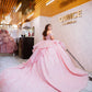 Vestido de quinceañera rosa pastel con olanes y encaje brillante